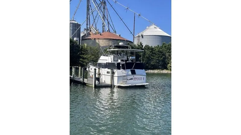 Slide: The Image of 1986 Carver 3607 Aft Cabin Motor Yacht with black canopy against clear blue sky. - 22
