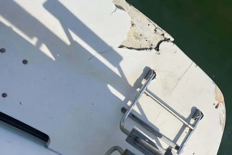 Slide: The Image of 1986 Carver 3607 Aft Cabin boat interior with helm, seating, and storage cabinets. - 8