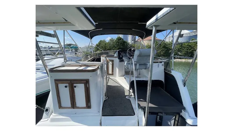 Slide: The Image of 1986 Carver 3607 Aft Cabin interior with helm, seating, and cabin view. - 9