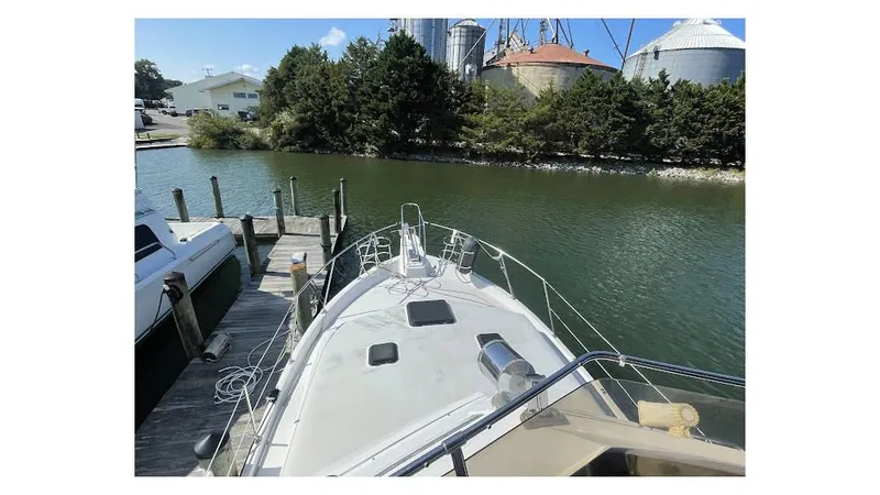 Slide: The Image of 1986 Carver 3607 Aft Cabin interior dining area with cushioned seating and decorative placemats. - 10