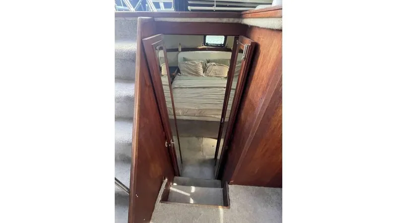 Slide: The Image of 1986 Carver 3607 Aft Cabin bathroom with toilet, sink, and shower area. - 16