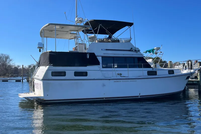 Slide: The Image of 1986 Carver 3607 Aft Cabin Motor Yacht docked on a sunny day. - 25