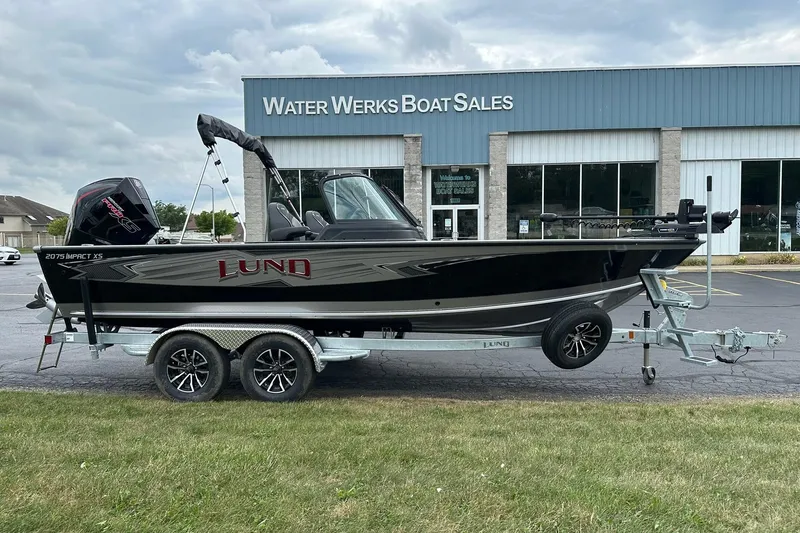 The Image of 2026 Lund 2075 Impact XS Sport boat on trailer outside Water Werks Boat Sales. - 0
