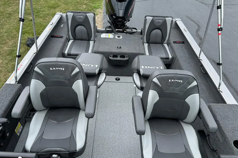 Slide: The Image of 2026 Lund 2075 Impact XS Sport boat interior with gray seating and spacious layout. - 11