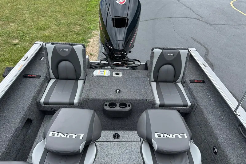 Slide: The Image of 2026 Lund 2075 Impact XS Sport boat interior with gray seating and motor. - 15