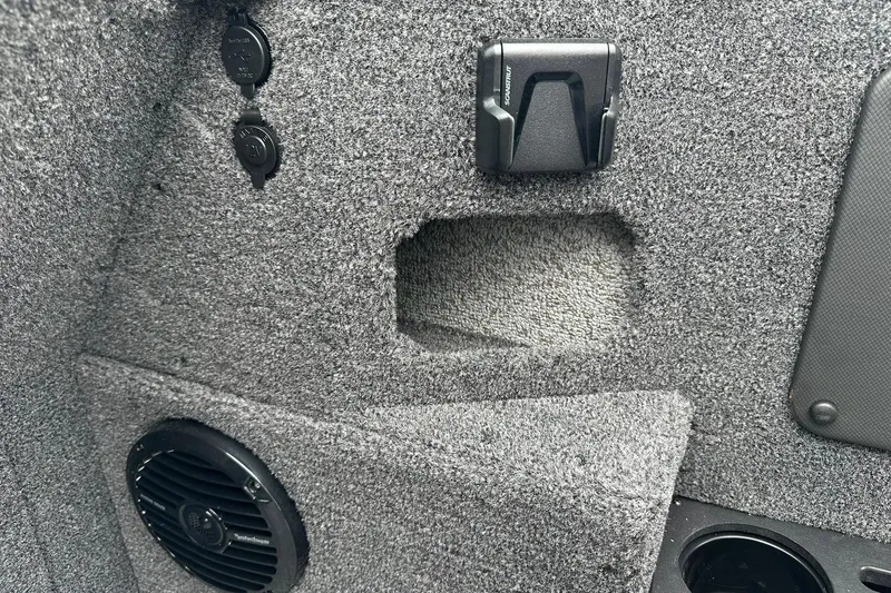 Slide: The Image of Interior detail of 2026 Lund 2075 Impact XS Sport boat, featuring speaker and accessory ports. - 23