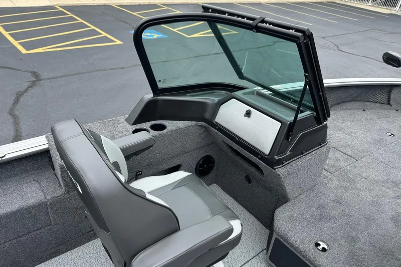 Slide: The Image of 2026 Lund 2075 Impact XS Sport boat interior with seating and windshield. - 24