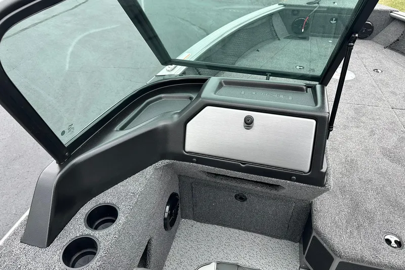 Slide: The Image of 2026 Lund 2075 Impact XS Sport boat interior with windshield and storage compartment. - 25