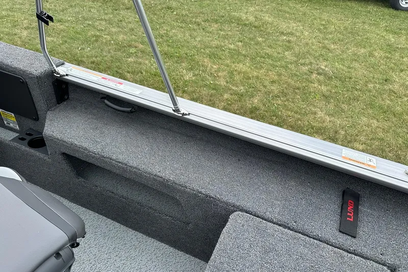 Slide: The Image of Interior view of 2026 Lund 2075 Impact XS Sport boat with gray seating and storage. - 27