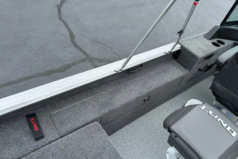 Slide: The Image of 2026 Lund 2075 Impact XS Sport boat interior with seating and storage features. - 28