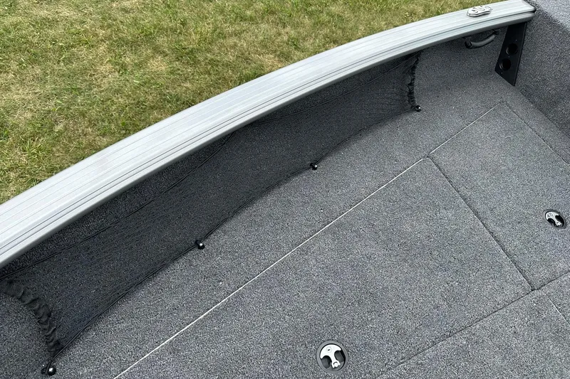 Slide: The Image of 2026 Lund 2075 Impact XS Sport boat interior with gray carpet and storage compartments. - 31