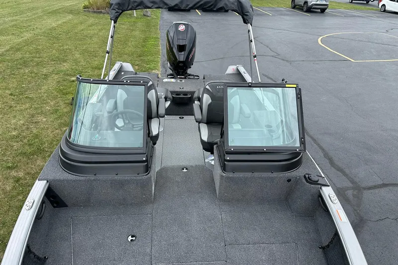 Slide: The Image of 2026 Lund 2075 Impact XS Sport boat with dual consoles and outboard motor. - 32