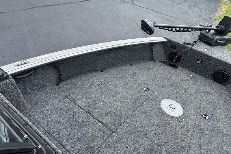 Slide: The Image of 2026 Lund 2075 Impact XS Sport boat deck with carpeted surface and trolling motor. - 33