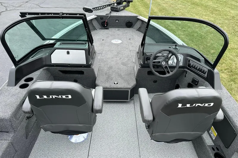 Slide: The Image of 2026 Lund 2075 Impact XS Sport boat interior with dual seats and steering console. - 8