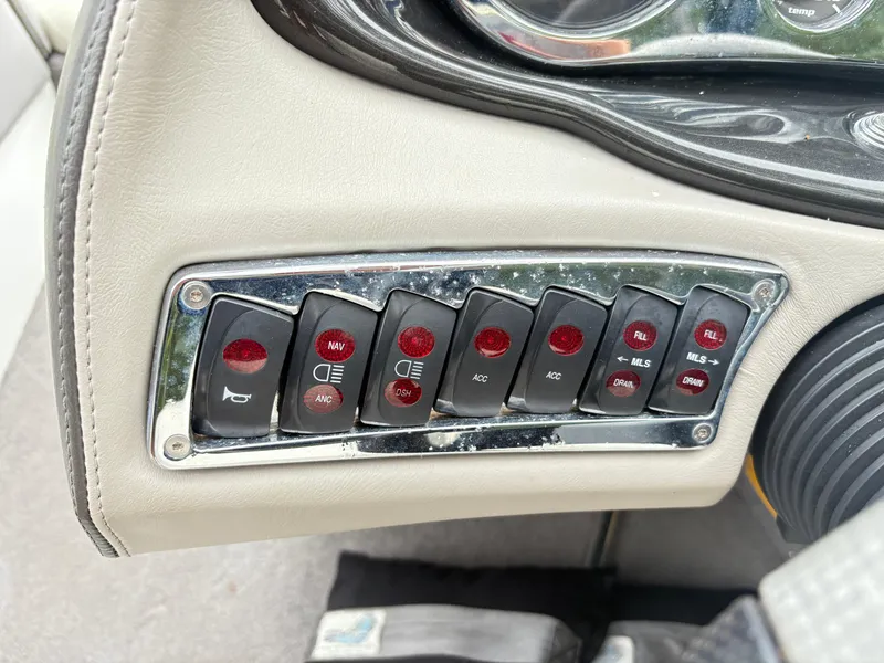 Slide: The Image of Control panel of a 2007 Malibu Wakesetter VTX boat with various switches. - 13