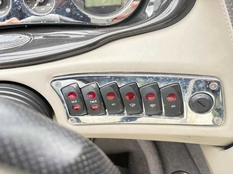 Slide: The Image of Dashboard controls of a 2007 Malibu Wakesetter VTX boat, featuring various switches and gauges. - 14