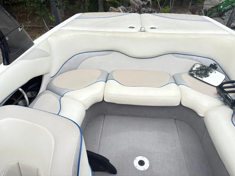 Slide: The Image of 2007 Malibu Wakesetter VTX interior with white and beige seating, blue trim, and a rearview mirror. - 18