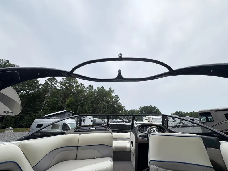 Slide: The Image of 2007 Malibu Wakesetter VTX interior with white seating and dashboard, parked outdoors. - 19