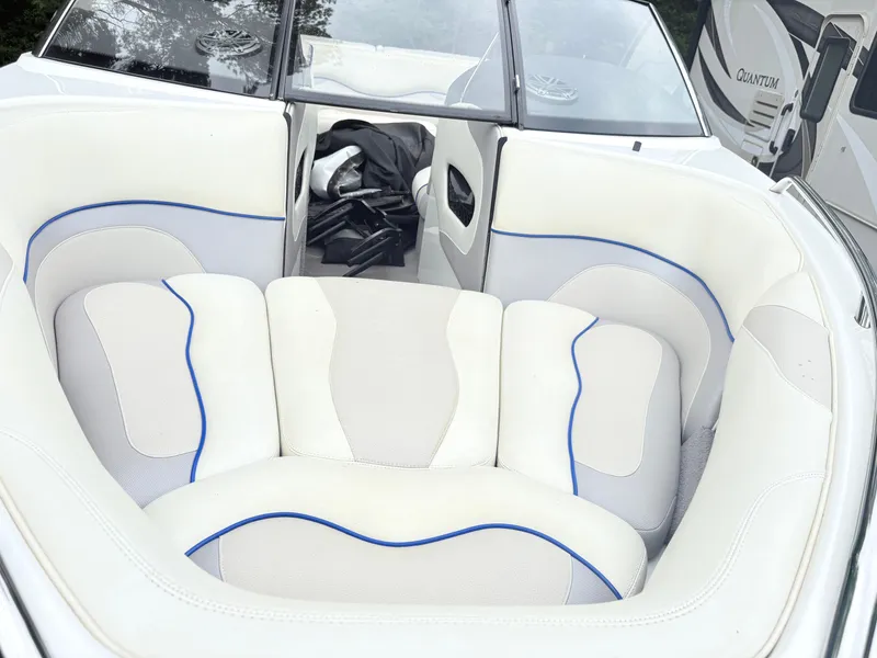 Slide: The Image of 2007 Malibu Wakesetter VTX boat interior with white and blue cushioned seating. - 7