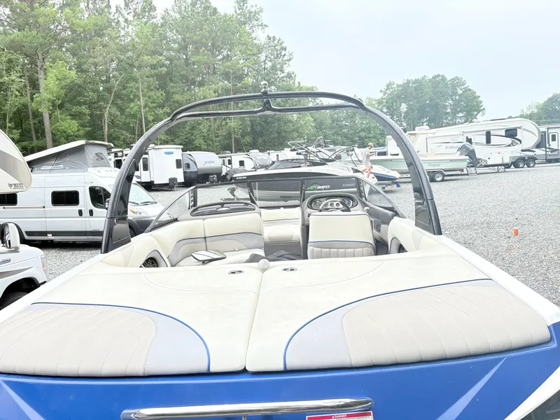 Slide: The Image of 2007 Malibu Wakesetter VTX boat in a parking lot with RVs and trees. - 8