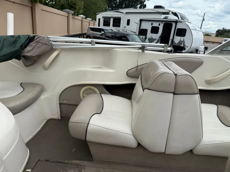 Slide: The Image of Interior of a 2002 Sea Ray 176 Bow Rider boat with white and gray seating. - 10