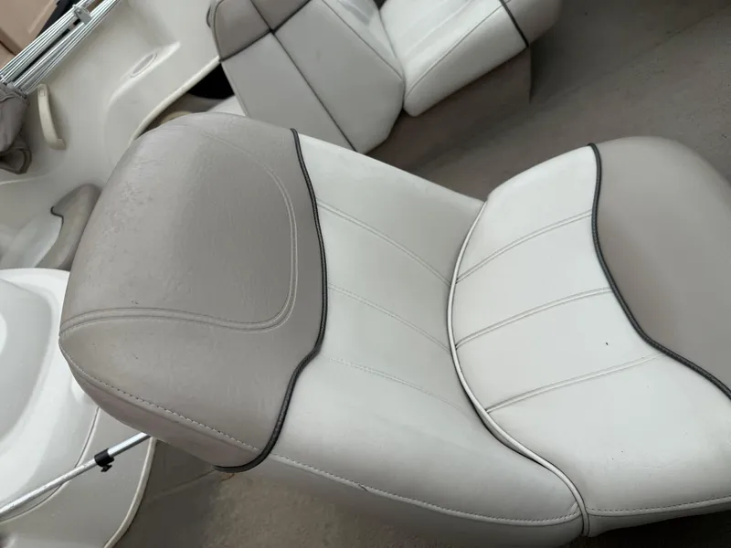 Slide: The Image of 2002 Sea Ray 176 Bow Rider interior with white and gray seating. - 14