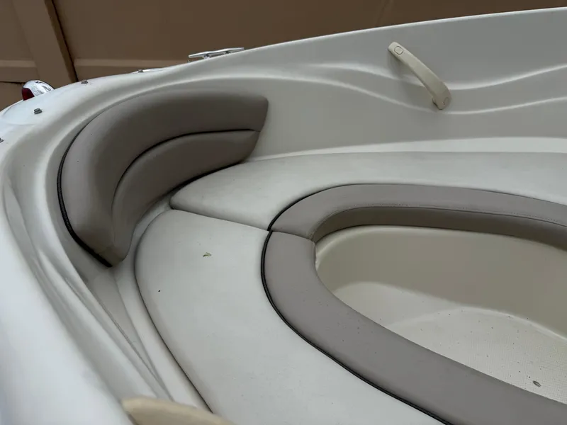 Slide: The Image of 2002 Sea Ray 176 Bow Rider interior seating, featuring cushioned bow area with beige upholstery. - 21