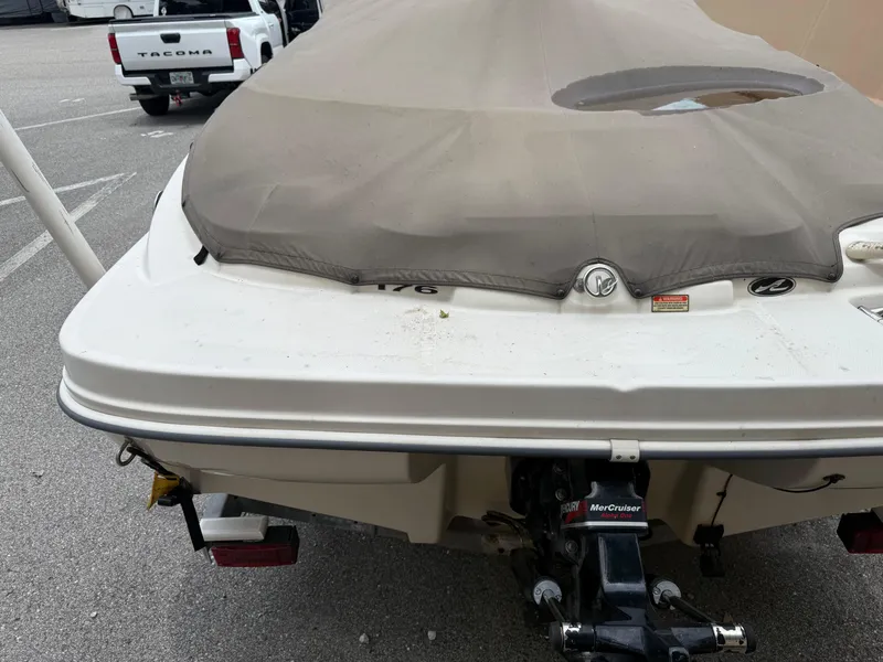 Slide: The Image of 2002 Sea Ray 176 Bow Rider with cover, parked in a lot. - 3