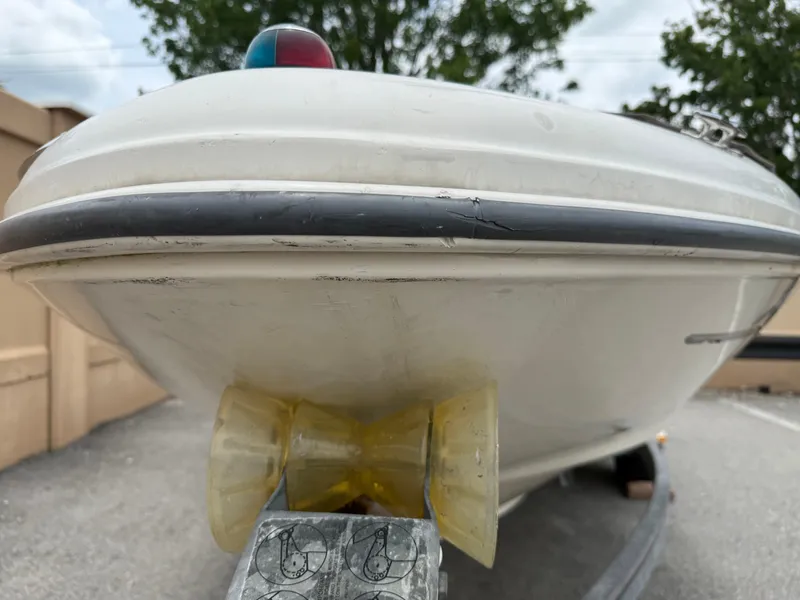 Slide: The Image of 2002 Sea Ray 176 Bow Rider boat on trailer, viewed from the front, outdoors. - 8