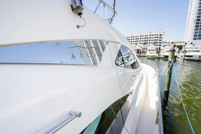 Slide: The Image of 2006 Aicon Flybridge yacht docked at marina, reflecting cityscape in windows. - 13