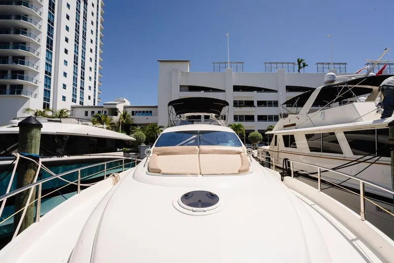 Slide: The Image of 2006 Aicon Flybridge yacht docked near modern buildings under clear blue sky. - 15