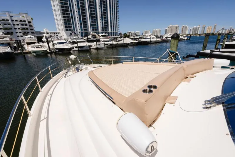 Slide: The Image of 2006 Aicon Flybridge yacht docked at marina with city skyline in background. - 17