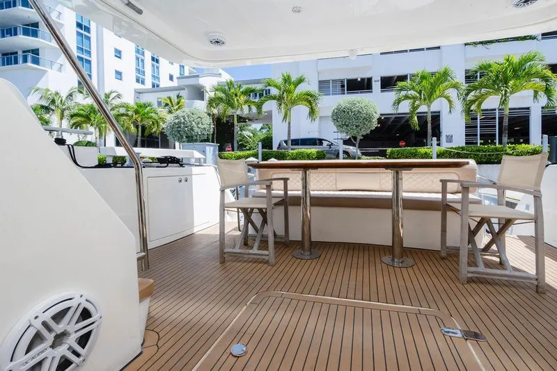 Slide: The Image of Luxury 2006 Aicon Flybridge yacht deck with seating and table, surrounded by palm trees. - 28