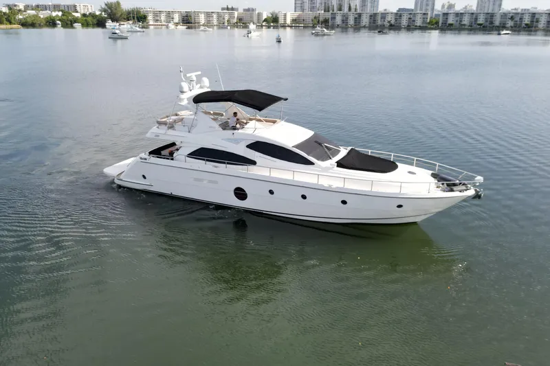 Slide: The Image of Aicon Flybridge 2006 yacht cruising on calm waters near urban skyline. - 3