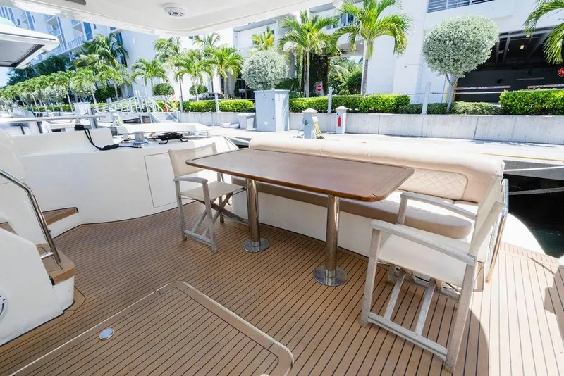 Slide: The Image of Luxury 2006 Aicon Flybridge yacht deck with seating and table, surrounded by palm trees. - 30