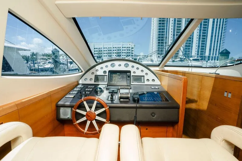 Slide: The Image of Helm of 2006 Aicon Flybridge yacht with modern controls and cityscape view. - 33