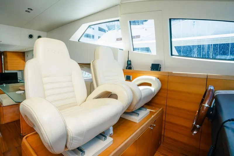 Slide: The Image of Interior of 2006 Aicon Flybridge yacht with luxurious white leather seats and wooden accents. - 39