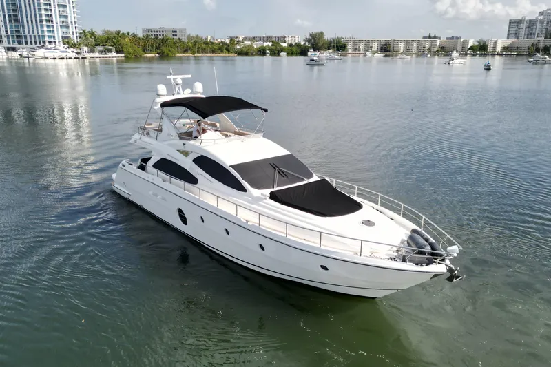 Slide: The Image of 2006 Aicon Flybridge yacht cruising in a serene marina setting. - 4