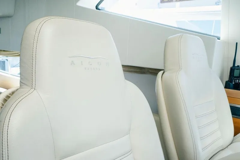Slide: The Image of Luxurious white leather seats in a 2006 Aicon Flybridge yacht interior. - 40