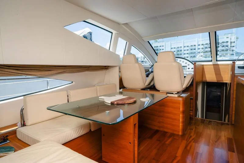 Slide: The Image of Luxurious interior of 2006 Aicon Flybridge yacht with glass table and plush seating. - 41