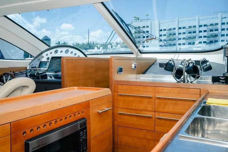 Slide: The Image of Luxurious 2006 Aicon Flybridge yacht interior with modern kitchen and navigation controls. - 43