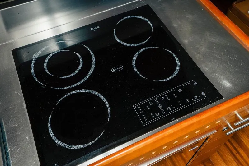 Slide: The Image of Stovetop on 2006 Aicon Flybridge yacht, featuring a sleek black design and modern controls. - 44
