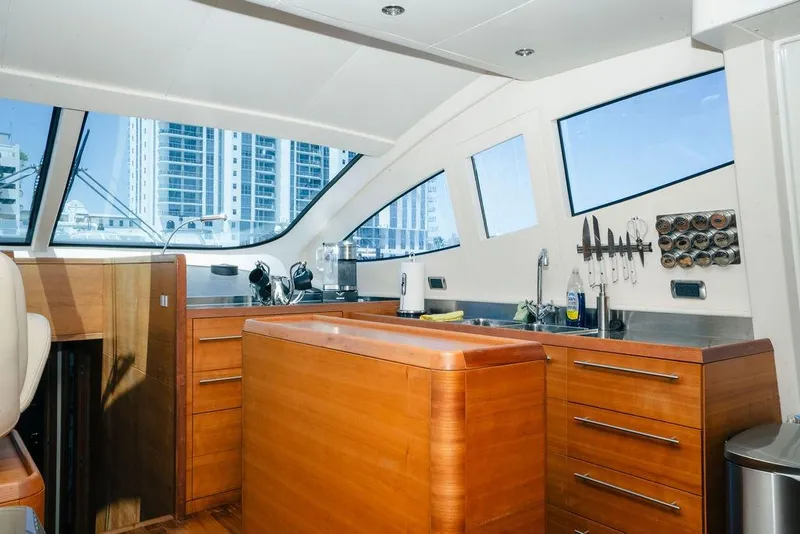 Slide: The Image of Luxurious 2006 Aicon Flybridge yacht kitchen with wooden cabinetry and modern amenities. - 48