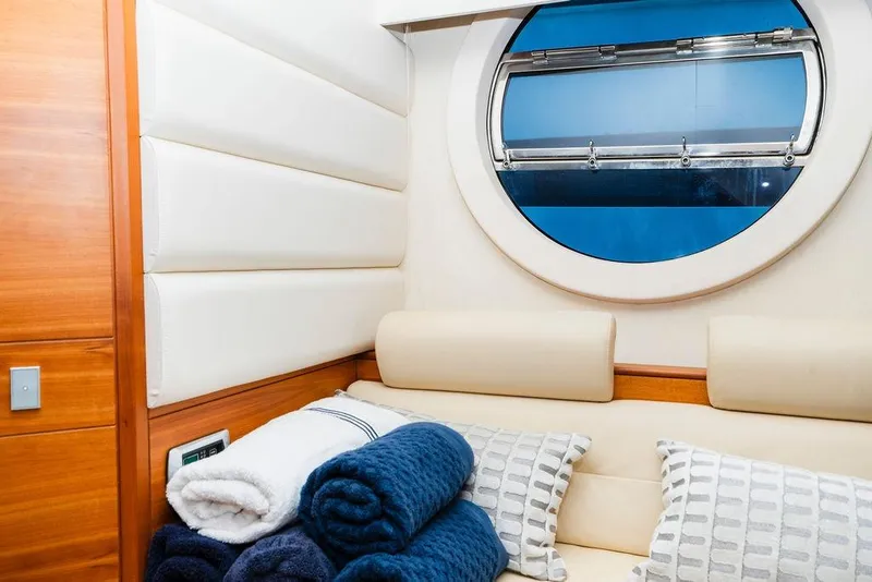 Slide: The Image of Luxurious interior of 2006 Aicon Flybridge yacht with plush seating and round window. - 65