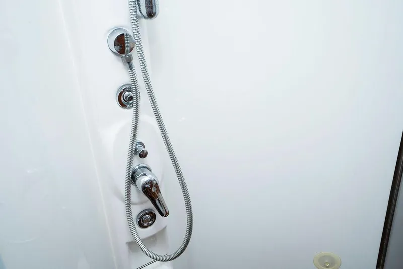 Slide: The Image of Shower controls in 2006 Aicon Flybridge yacht bathroom, featuring chrome fixtures and white paneling. - 68