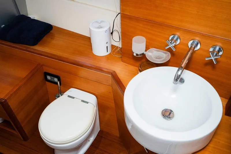 Slide: The Image of Luxury yacht bathroom with wooden finish, featuring a sink and toilet. Aicon Flybridge 2006 model. - 70