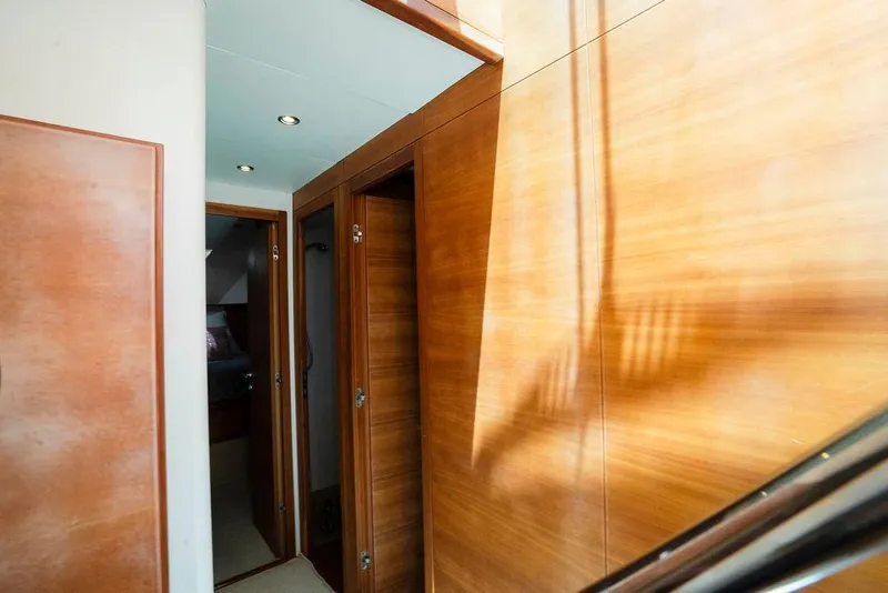 Slide: The Image of Interior hallway of 2006 Aicon Flybridge yacht with wooden paneling and doors. - 72