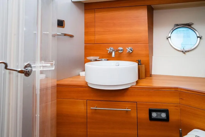 Slide: The Image of Luxurious 2006 Aicon Flybridge yacht bathroom with wooden cabinetry and modern fixtures. - 76
