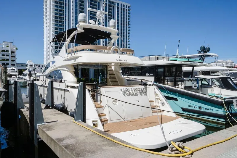 Slide: The Image of Luxury 2006 Aicon Flybridge yacht docked at marina with modern buildings in background. - 9