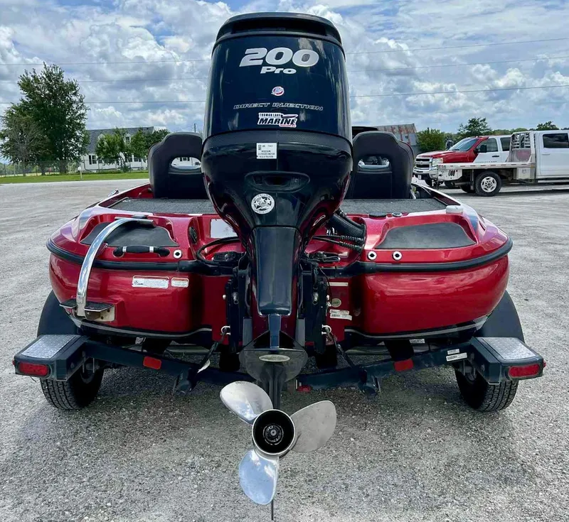 Slide: The Image of 2018 Nitro Z19 boat with 200 Pro outboard motor, parked on a trailer. - 11